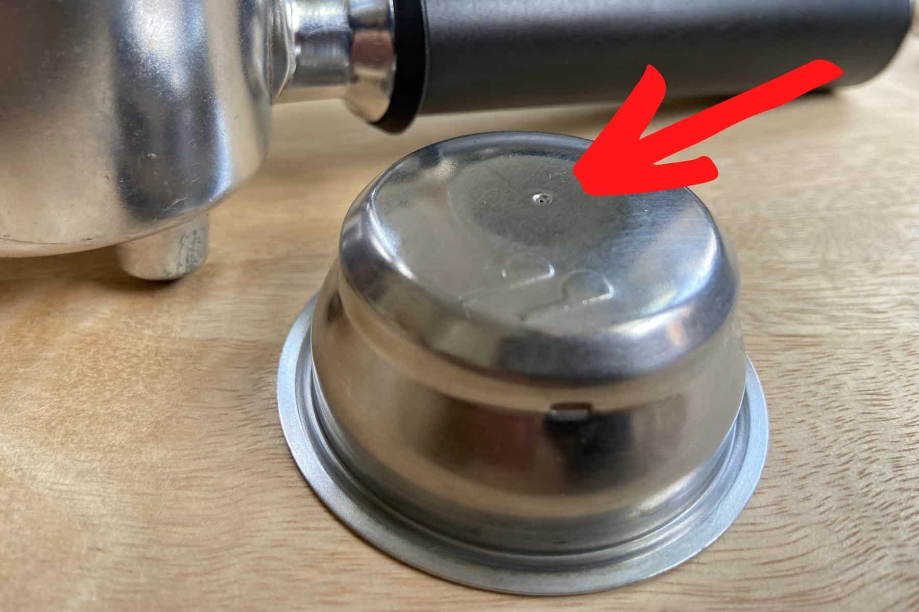 The hole in the coffee basket that can get clogged on a delonghi dedica