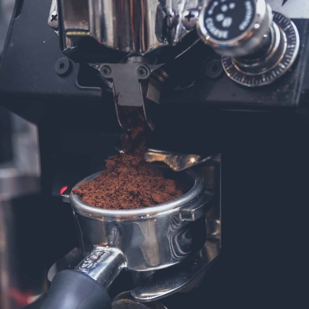 ground coffee coming out of the grinder
